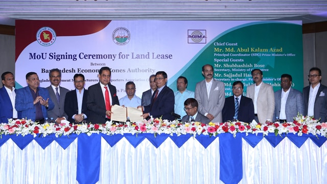 BGMEA President Siddiqur Rahman and BEZA Executive Member Md Harunur Rashid exchanging documents at the MoU signing ceremony in Dhaka